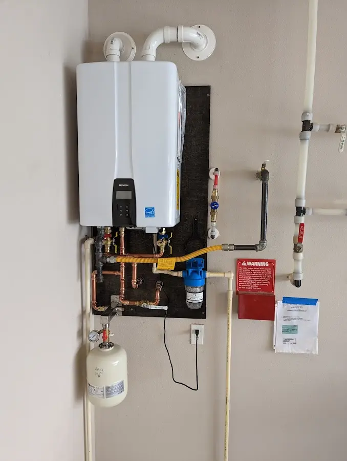 Professional plumber installing copper piping in a Surfside home